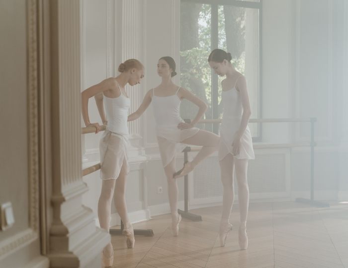 adult ballet dancers warming up